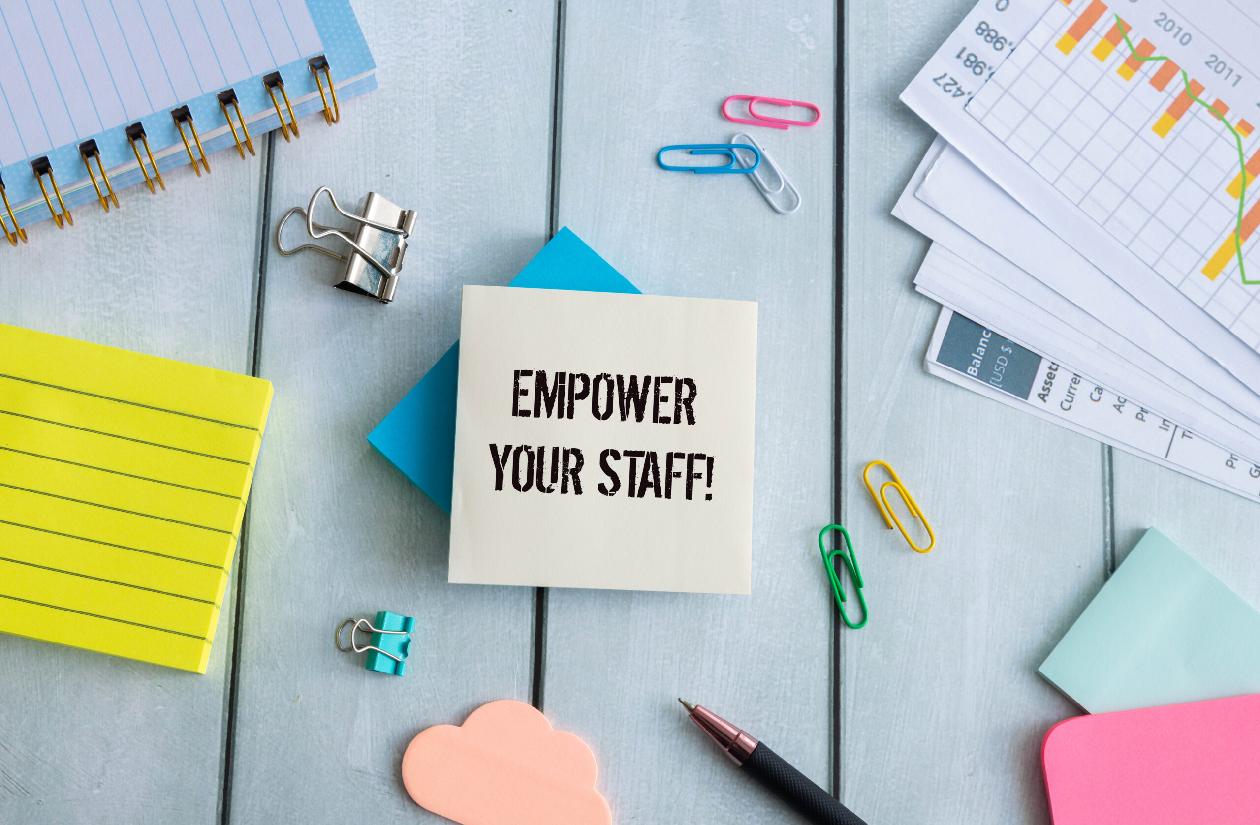 Wooden blocks with words 'Empower your staff'.