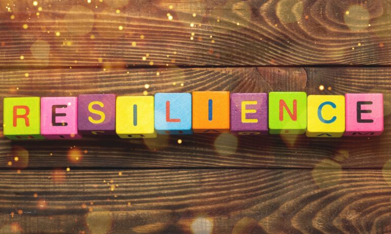 Resilience sign with wooden cubes on background