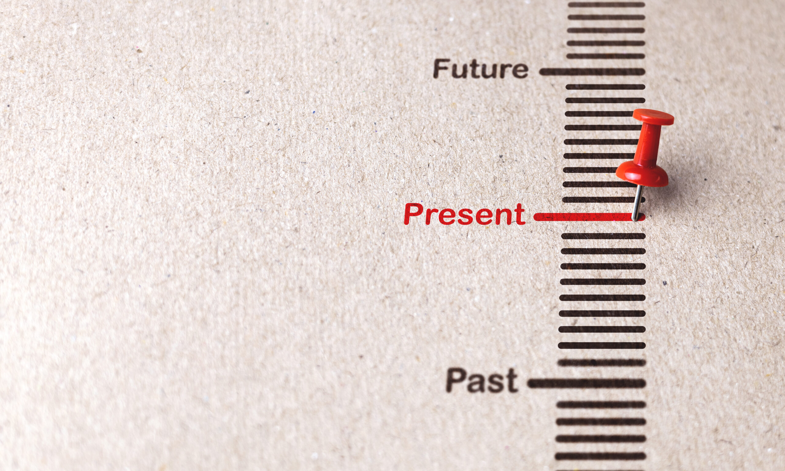 Red pin marks Present on paper background for focusing on current affairs, popular business trends concept.