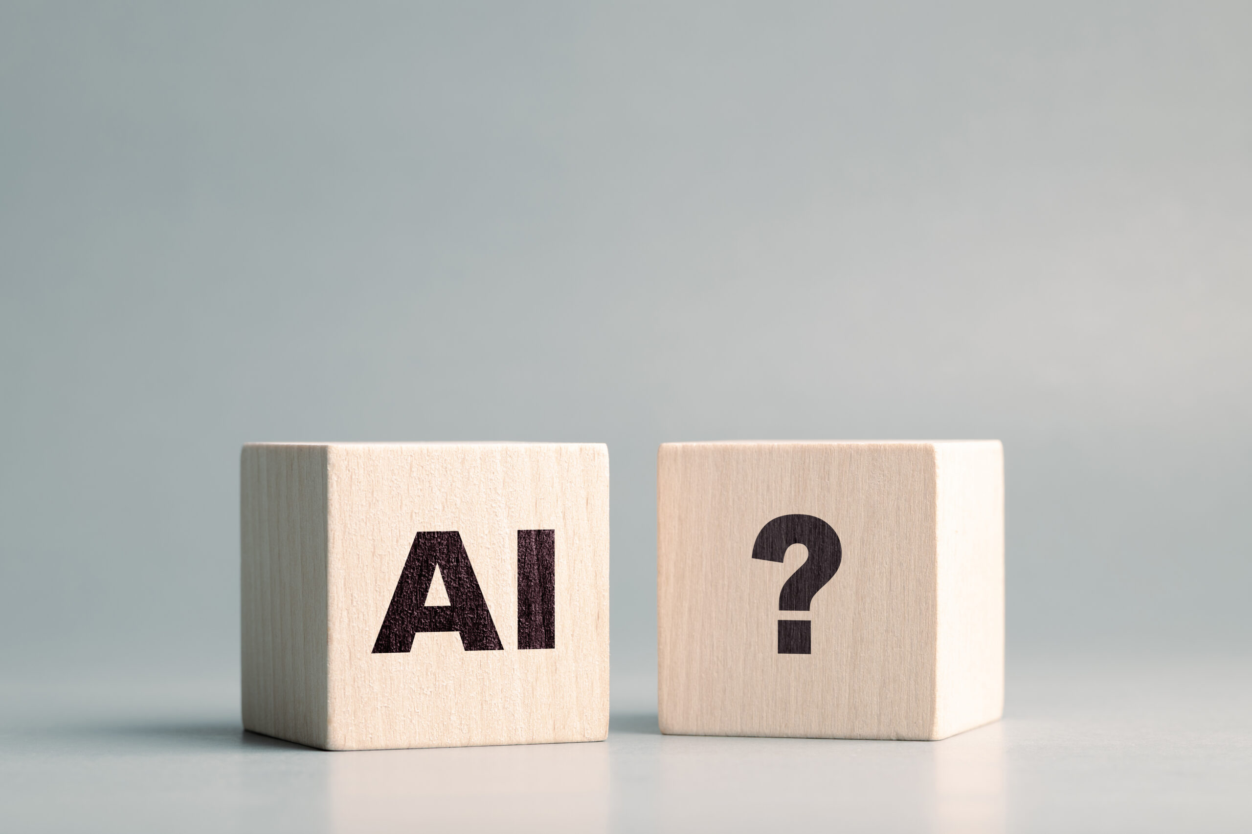 AI text and Question mark symbol on the wooden cubes, confusion about AI, how to use, and ask, questions about AI technology