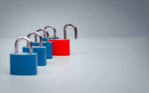 Red unlocked padlock with triangle warning symbol stands among secure blue locks with copy space, illustrating a single point of failure, cybersecurity vulnerability and enterprise risk concept.