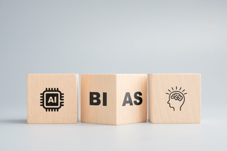 Artificial intelligence and bias in decision-making represented by AI chip, bias text, and human head icon on wooden blocks in a row