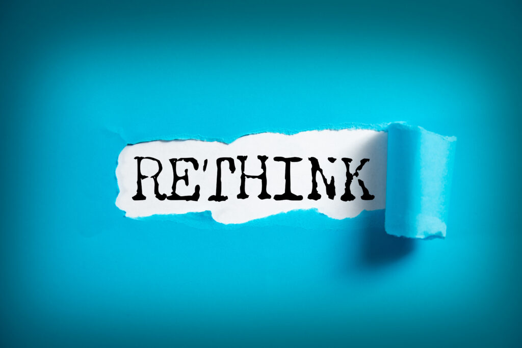 RETHINK word on white paper
