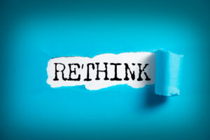 RETHINK word on white paper