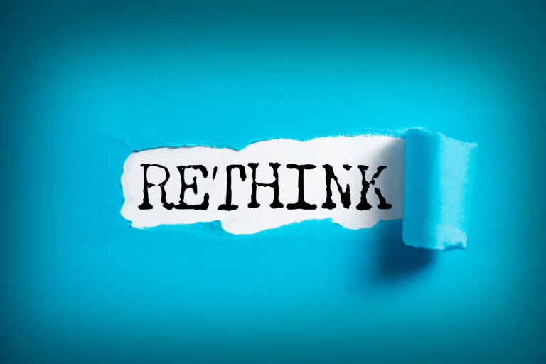 RETHINK word on white paper