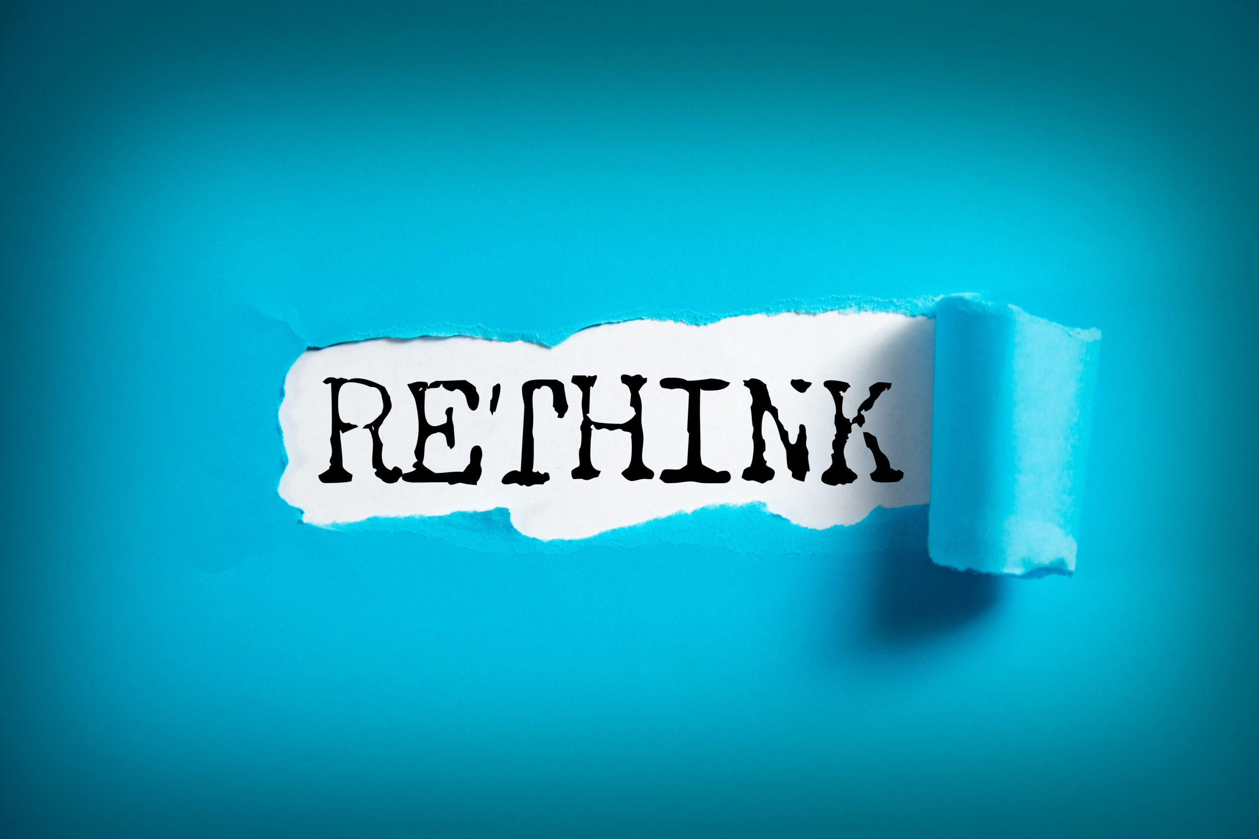RETHINK word on white paper